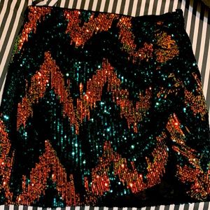 Sequence skirt with ruffle on the left side.